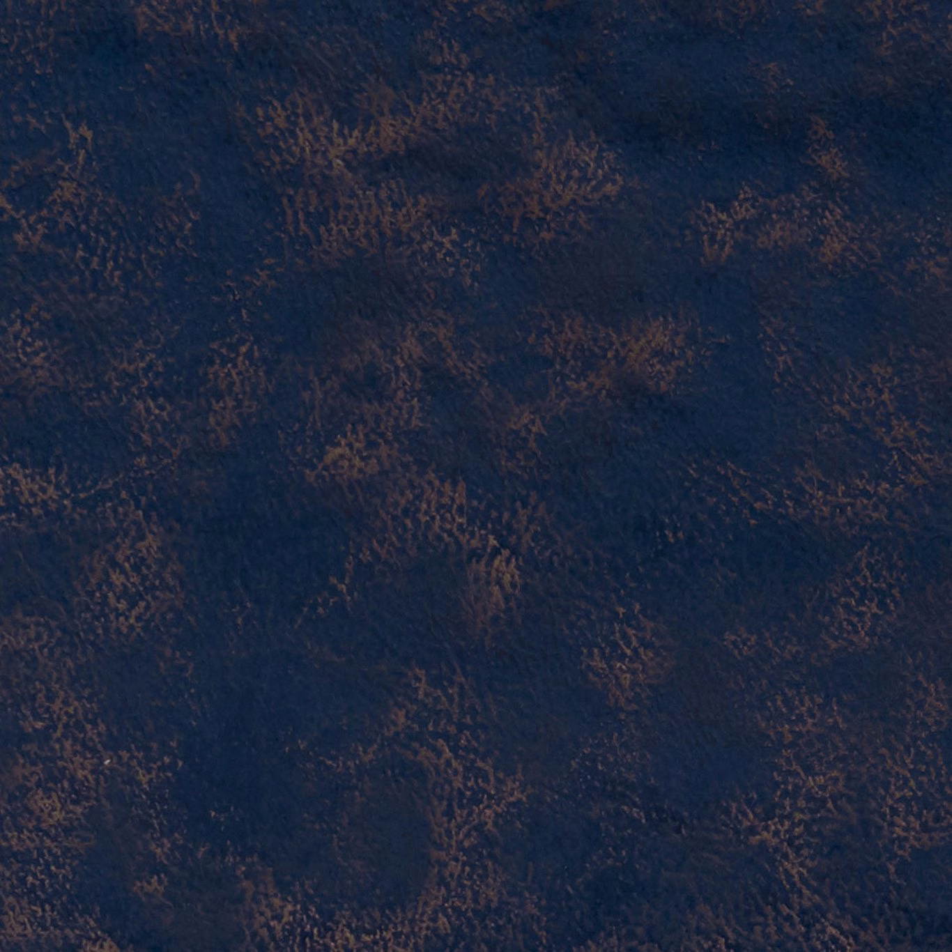 Deep indigo textured fabric with irregular russet-brown flecks and a softly mottled surface