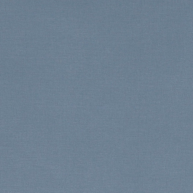 Muted chambray blue fabric with a fine, subtly mottled plain weave