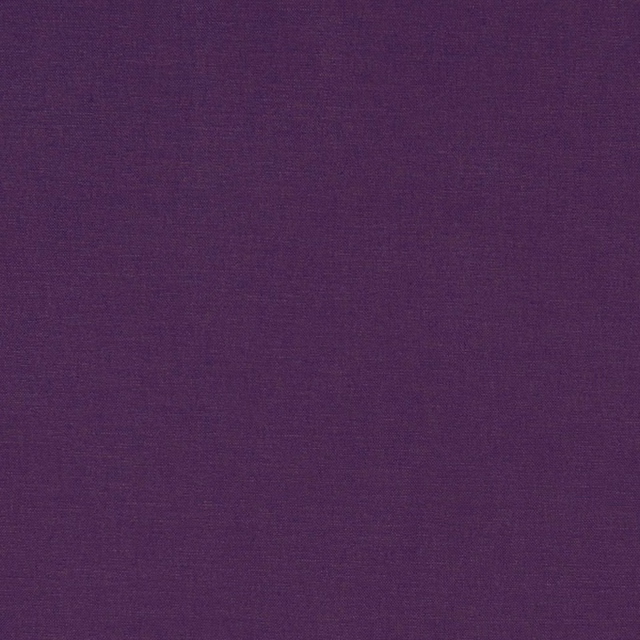 Close-up of deep plum purple fabric with a subtle fine woven texture