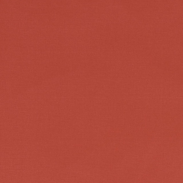 Close-up of warm brick-red Alora fabric with a fine, even woven texture