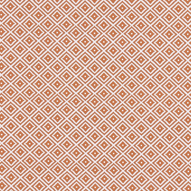 Warm terracotta and cream woven fabric with a tightly spaced diamond motif