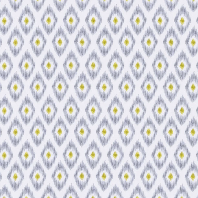 White textile with smoky grey diamond motifs and yellow-green centres