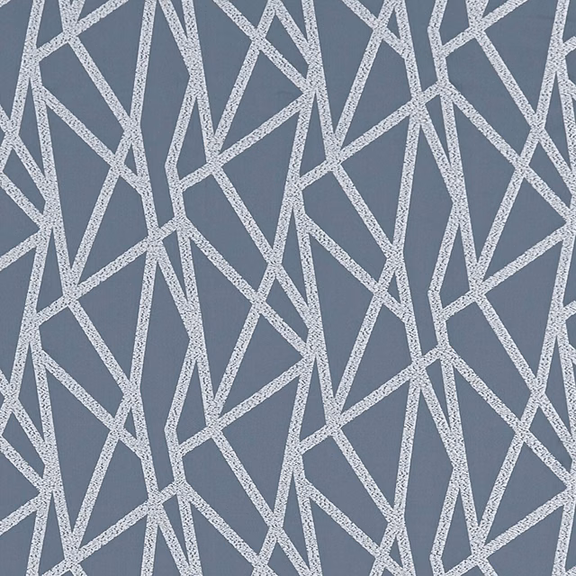 Slate blue-grey fabric with pale silver angular geometric lines and a tactile woven surface