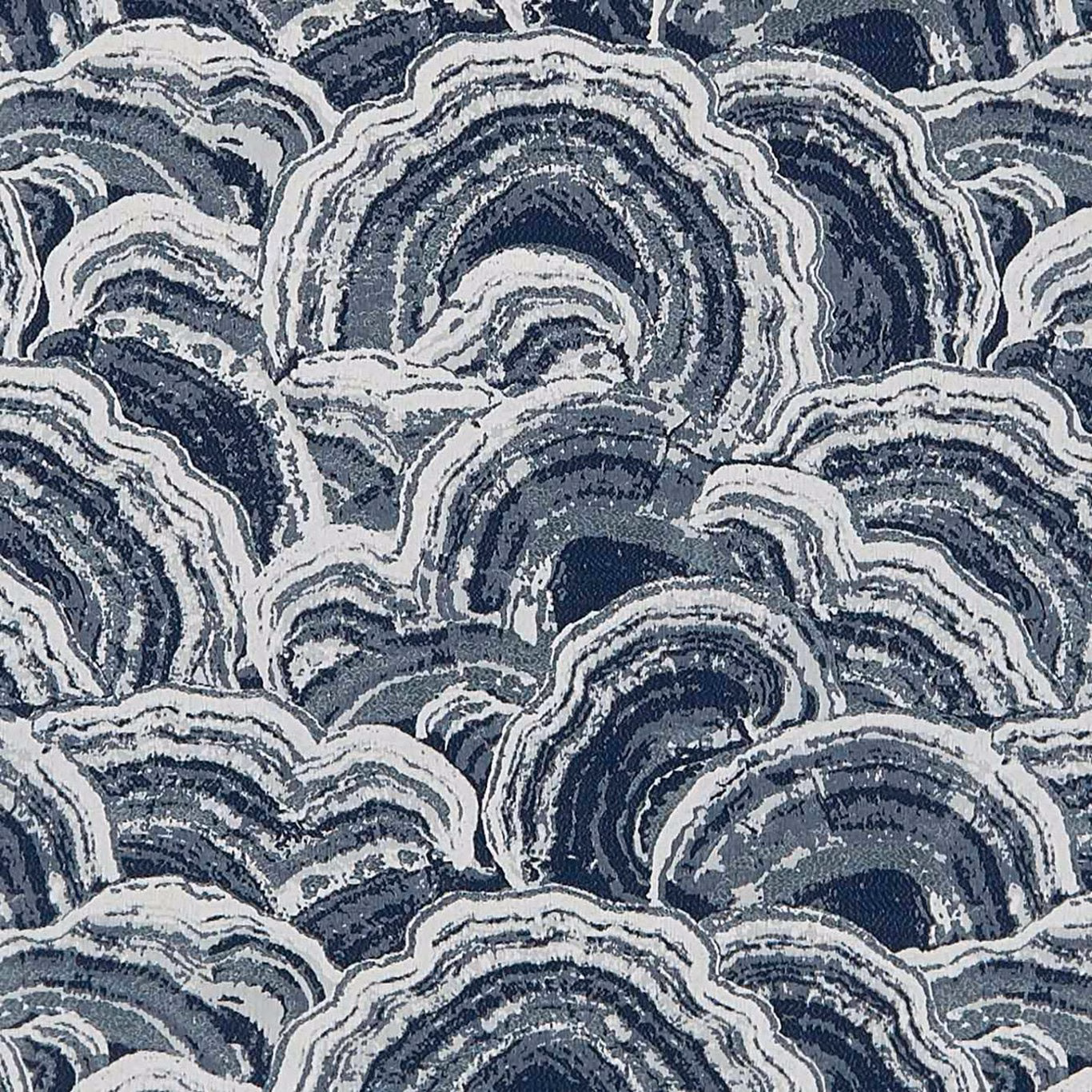 Ink blue woven fabric with chalk and slate wave-like arches in a dense repeating pattern