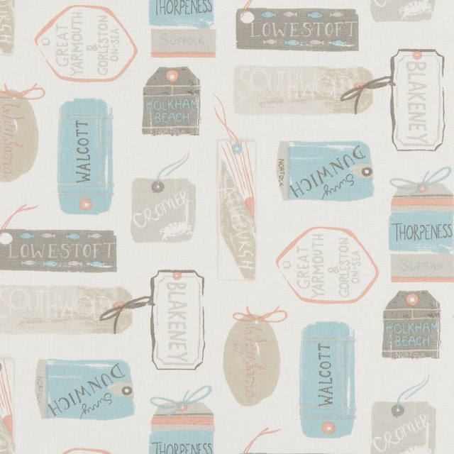 Pale pastel travel-label fabric with blue, sage, coral and grey coastal motifs