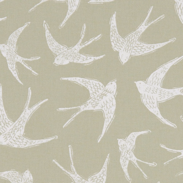 Ivory swallows flying across a muted sage-green woven fabric ground