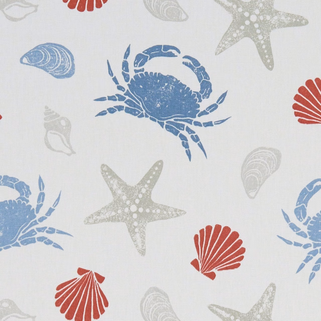 Marine blue crabs, coral shells and grey starfish scattered across pale woven fabric