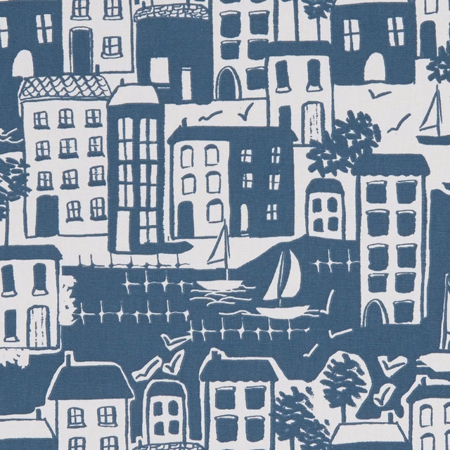 Deep navy harbour town with white buildings, sailboats, trees and water markings