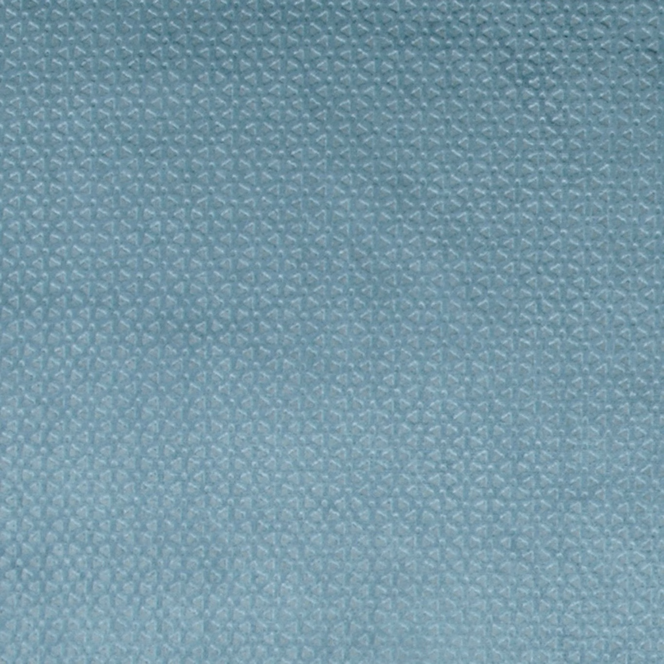 Close-up of muted blue-teal fabric with tiny angular geometric woven marks and subtle texture