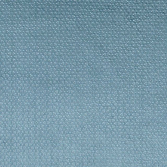 Close-up of muted blue-teal fabric with tiny angular geometric woven marks and subtle texture