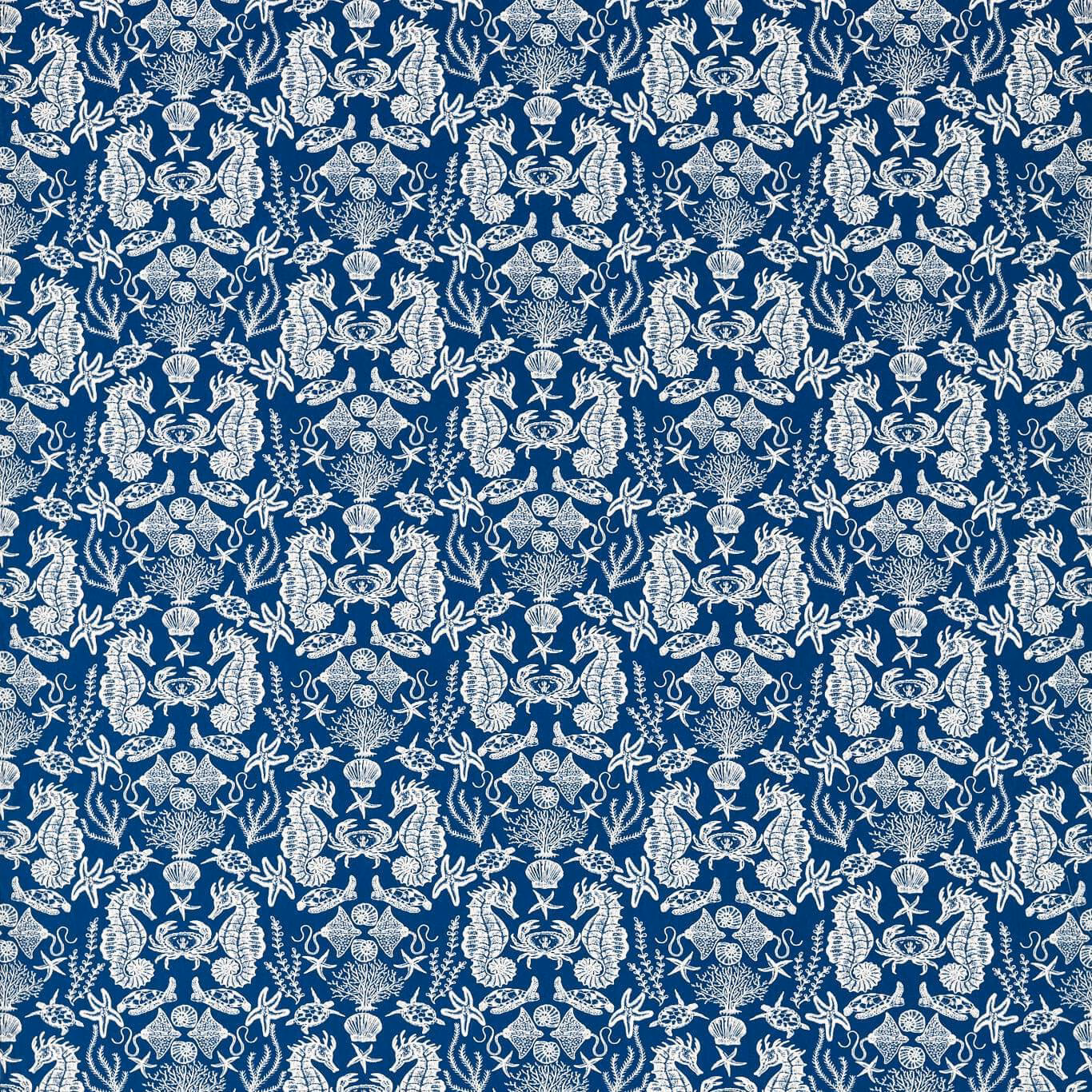 Deep navy fabric with ivory shells, starfish and ornate marine motifs in a dense repeat