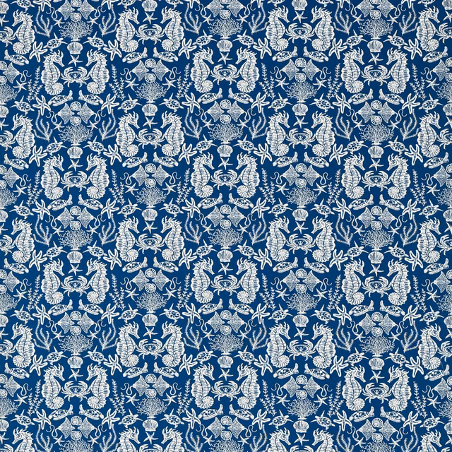 Deep navy fabric with ivory shells, starfish and ornate marine motifs in a dense repeat