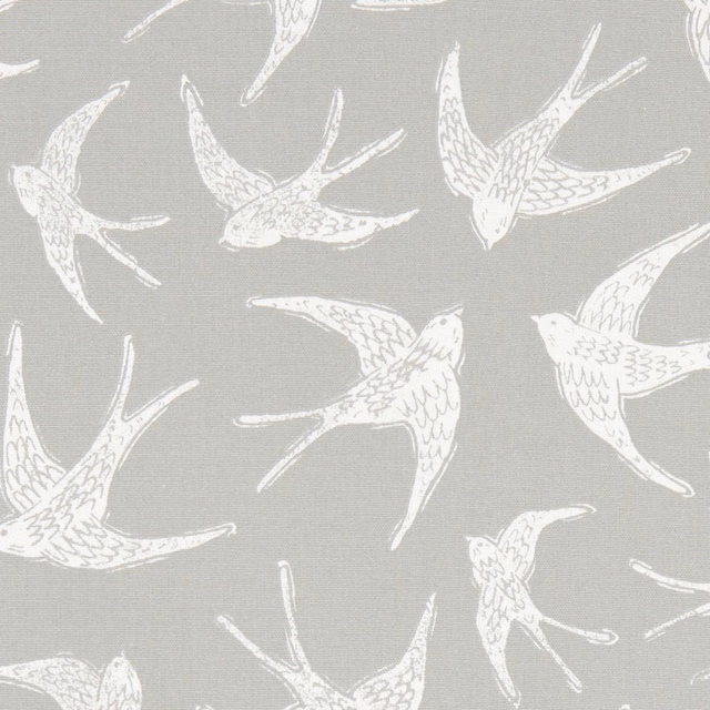 Ivory swallows in flight across a cool grey woven fabric ground