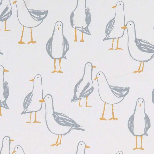 Warm ivory fabric with soft grey seagulls and ochre beaks and legs