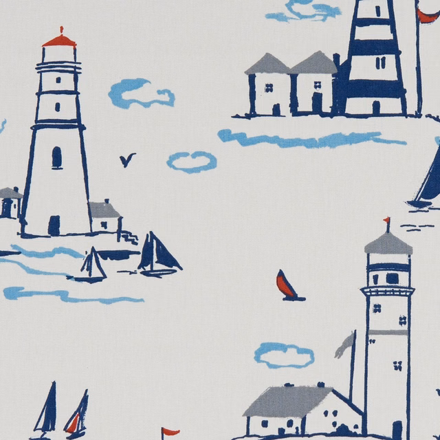 Off-white nautical print with navy lighthouses, pale blue waves and red sails