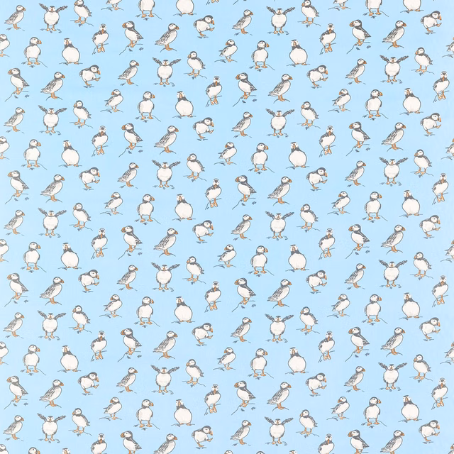 Powder-blue fabric with small white and grey illustrated seabirds in a repeating pattern