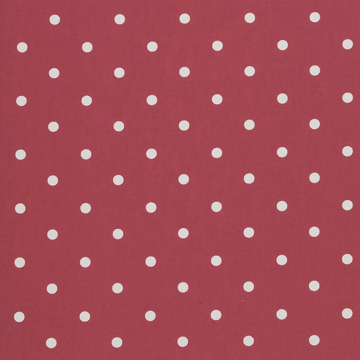 Raspberry-red woven fabric with evenly spaced small cream polka dots