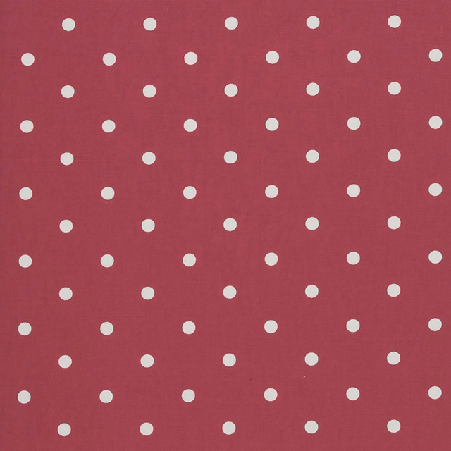 Raspberry-red woven fabric with evenly spaced small cream polka dots