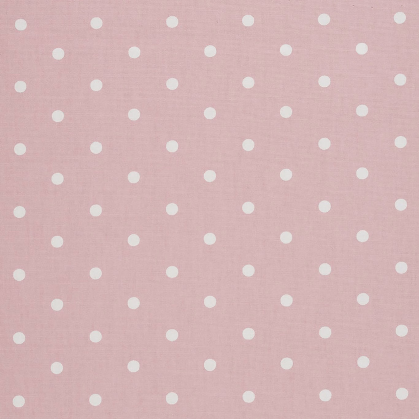 Dusty blush pink woven fabric with evenly spaced ivory dots