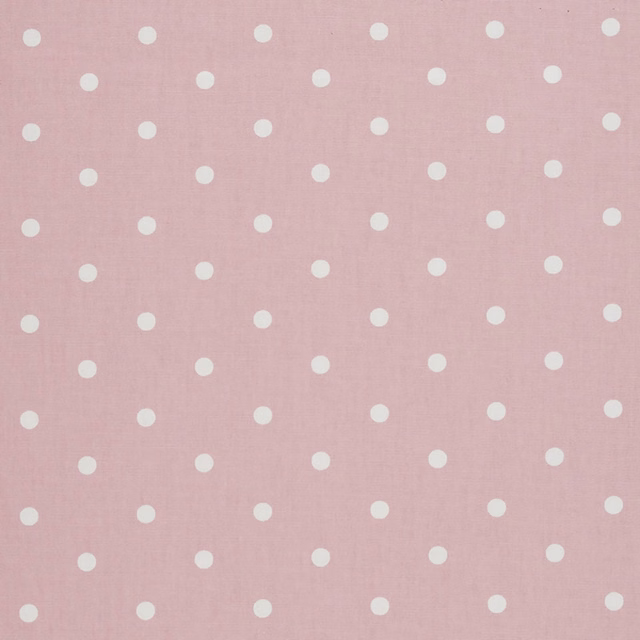 Dusty blush pink woven fabric with evenly spaced ivory dots