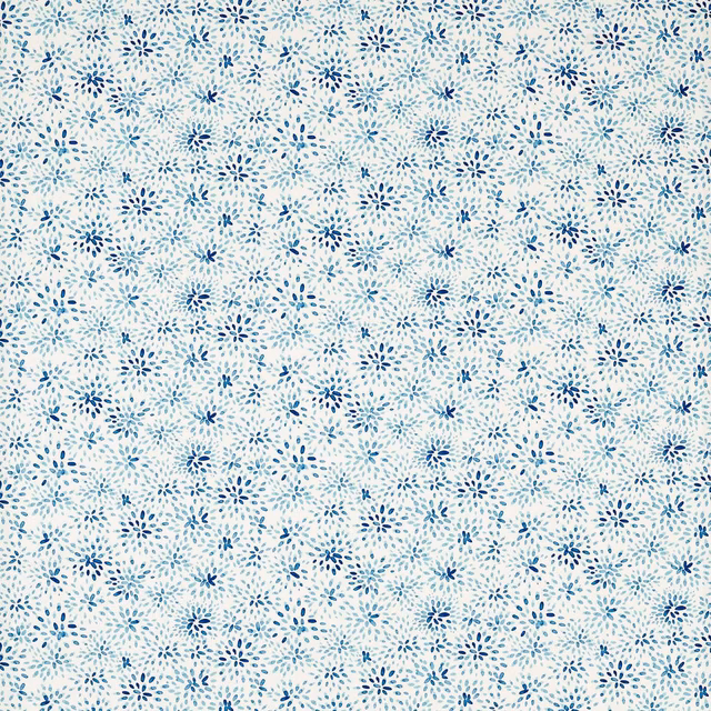 Cream fabric covered in small scattered cobalt and pale blue floral sprigs