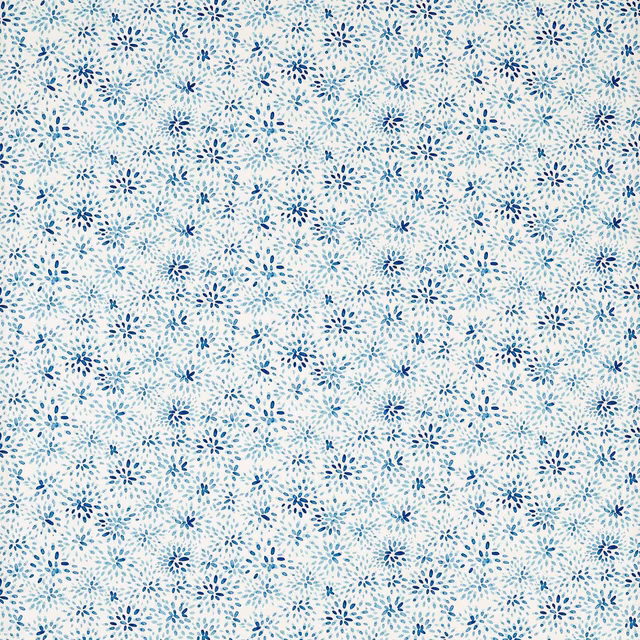 Dense tiny cobalt and pale blue floral sprays across an ivory textile ground