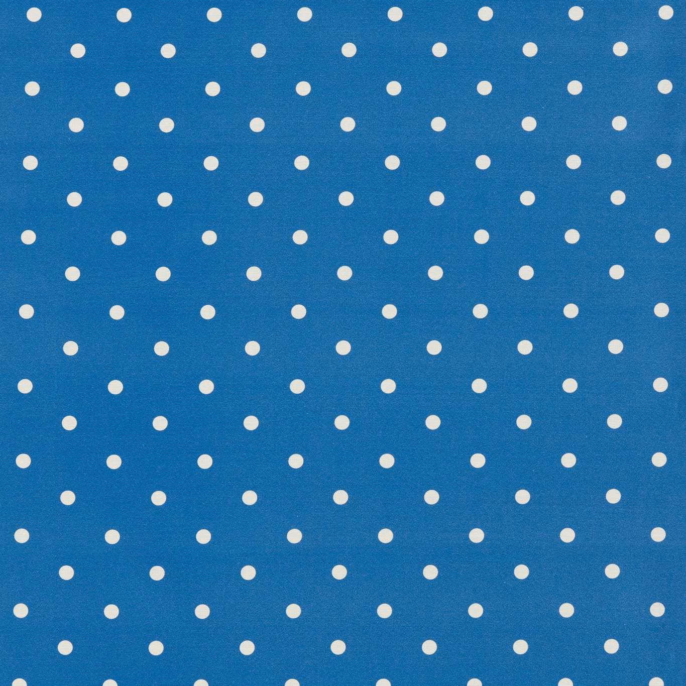 Cobalt blue woven fabric with evenly spaced small cream polka dots