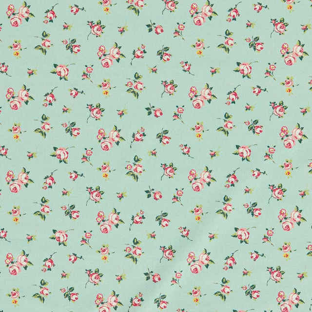 Mint-green floral fabric with scattered pink roses, cream blooms and leafy sprigs