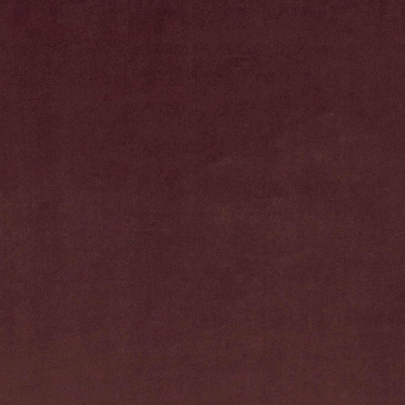 Deep oxblood fabric with subtle mottled texture and softly shifting burgundy tones