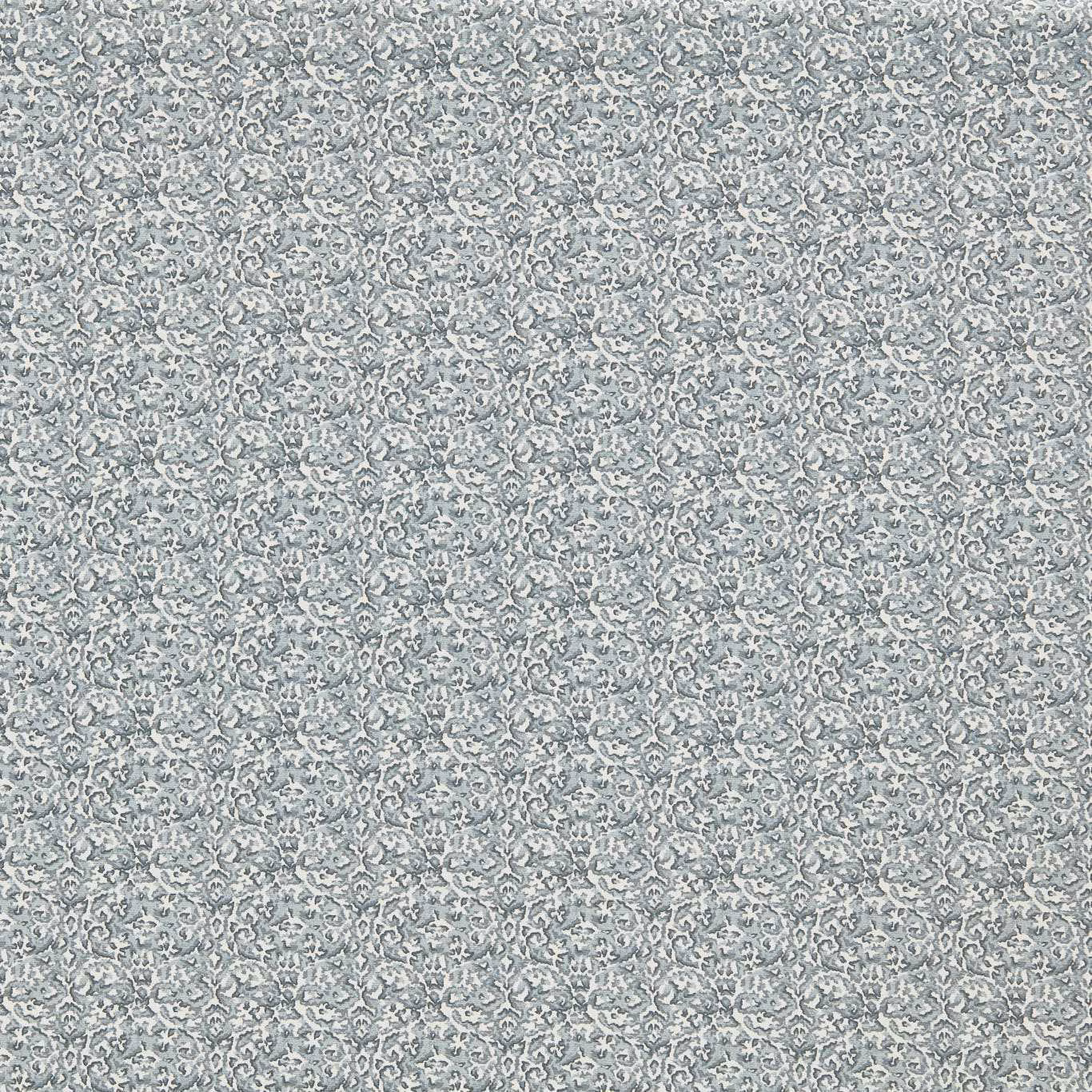 Muted denim blue-grey fabric with a tiny scrolling floral pattern and softly mottled texture