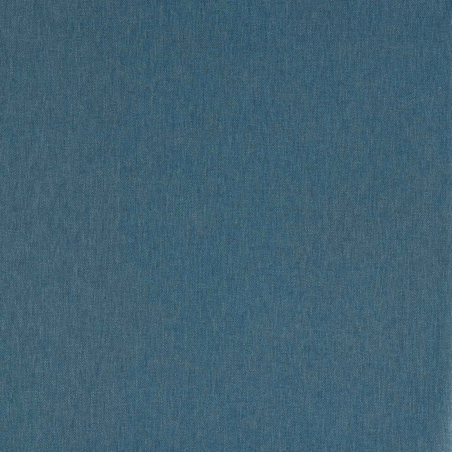 Close-up of muted denim-blue fabric with a fine, softly varied woven texture