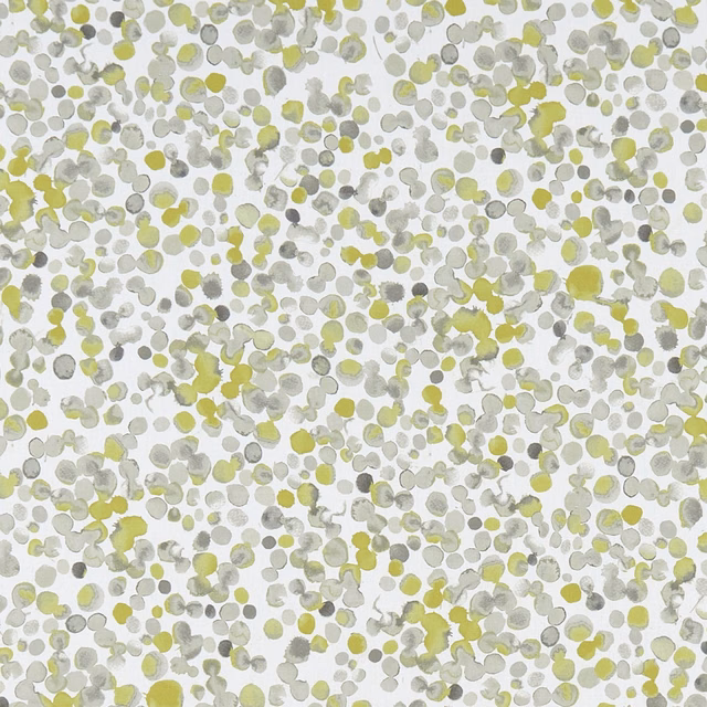 Small chartreuse, grey and white pebble-like marks scattered across a pale fabric ground