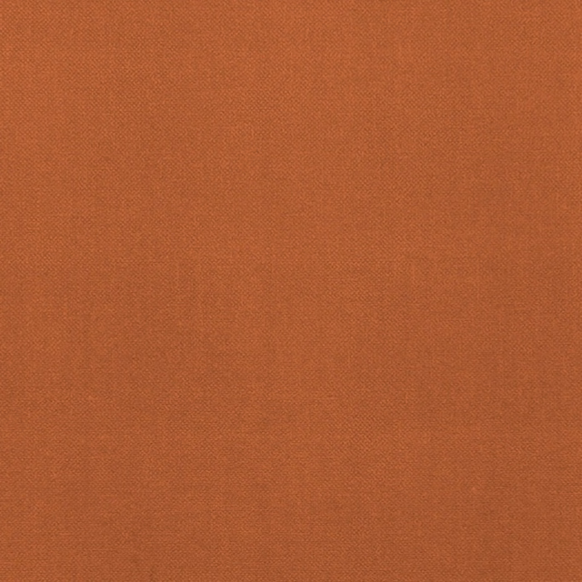 Close-up of warm spice terracotta fabric with a fine, even woven texture