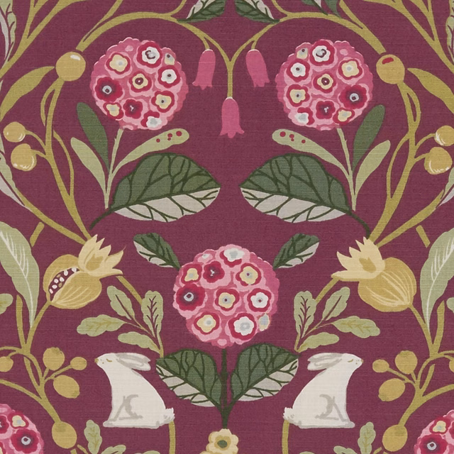 Deep plum botanical fabric with pink flower heads, olive leaves and pale ornamental figures