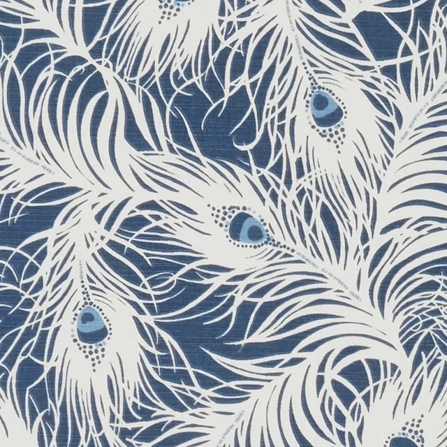 Denim-blue ground with ivory peacock feathers, dotted eyes and fine sweeping lines