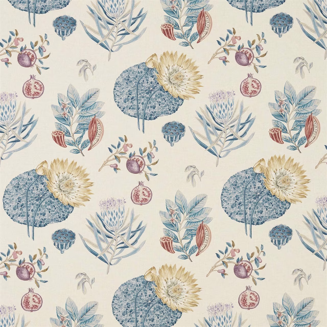 Printed botanical fabric on cream ground with indigo-blue leaves and ruby berry motifs