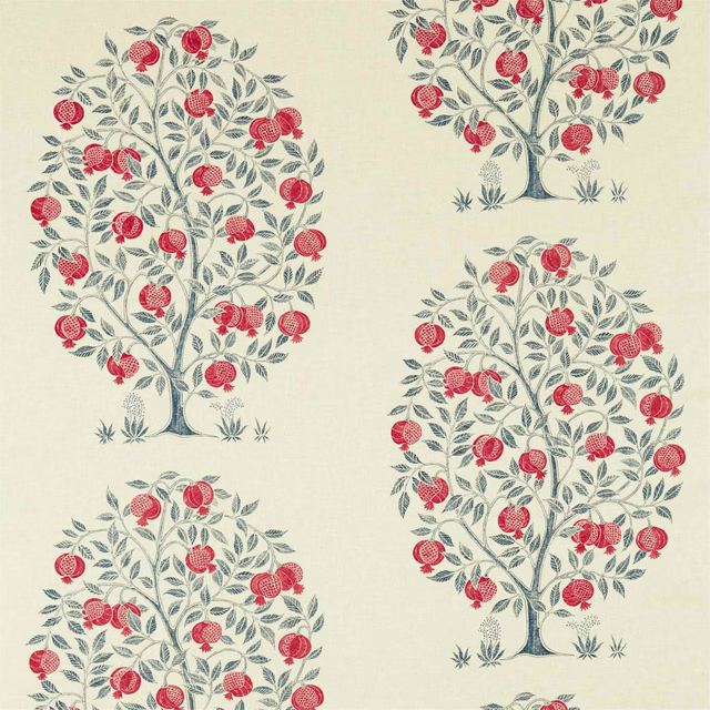 Cream fabric swatch with blue-grey fruit trees and bright crimson pomegranates