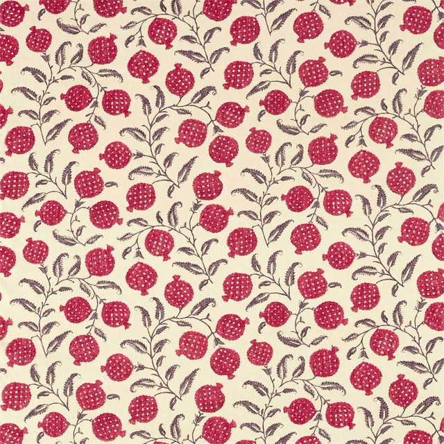 Cherry-red pomegranate motif with dark leafy stems on a pale ground