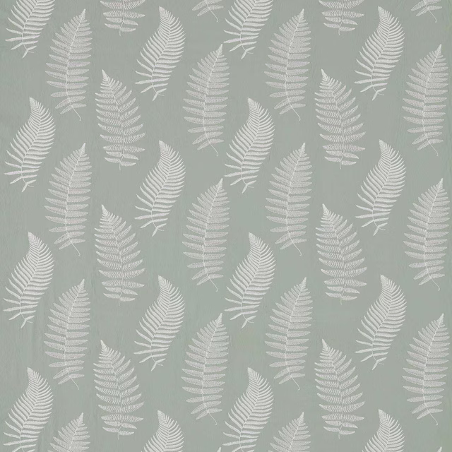 Pale mist-green fabric with white embroidered fern fronds in a scattered botanical pattern