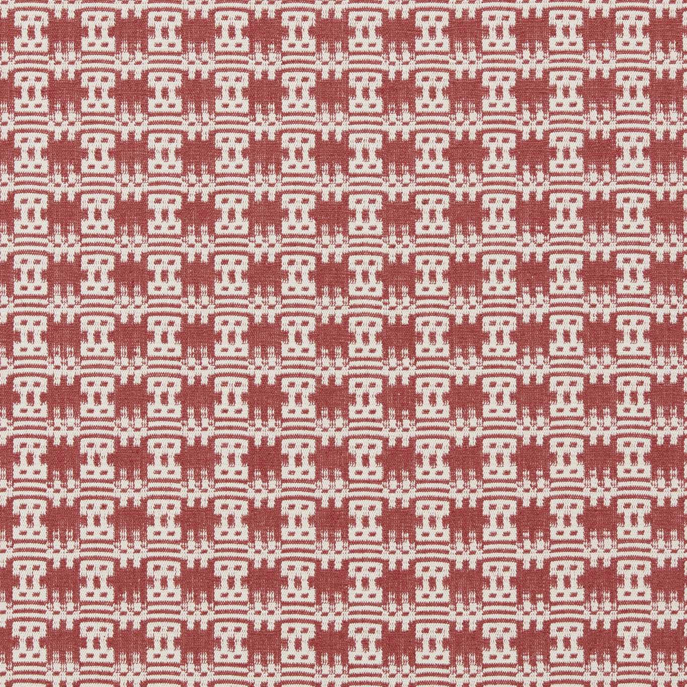 Close-up of a woven pink-red geometric fabric with cream repeated motifs