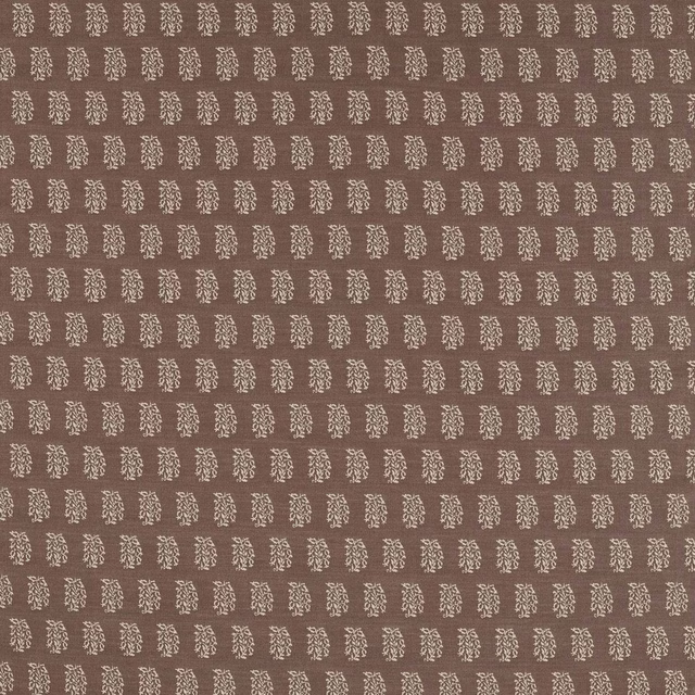 Close-up of cocoa brown woven fabric with small pale floral motifs in neat rows