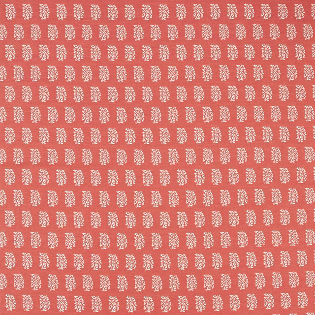 Coral-pink woven fabric with small cream repeating motif