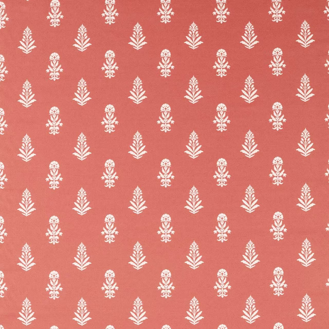 Coral terracotta fabric with small white repeating leaf motifs