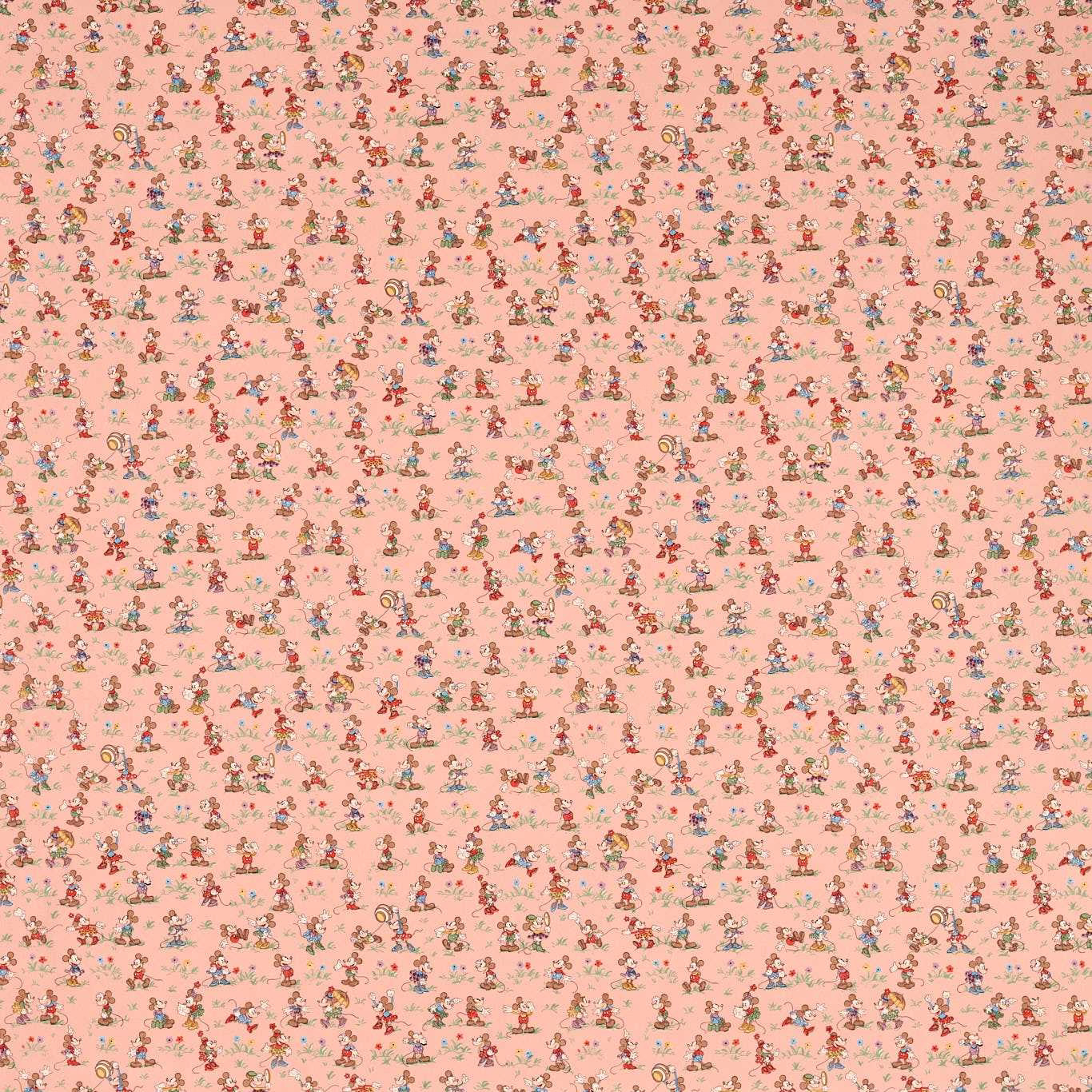 Blush pink fabric scattered with tiny multicoloured Mickey and Minnie motifs