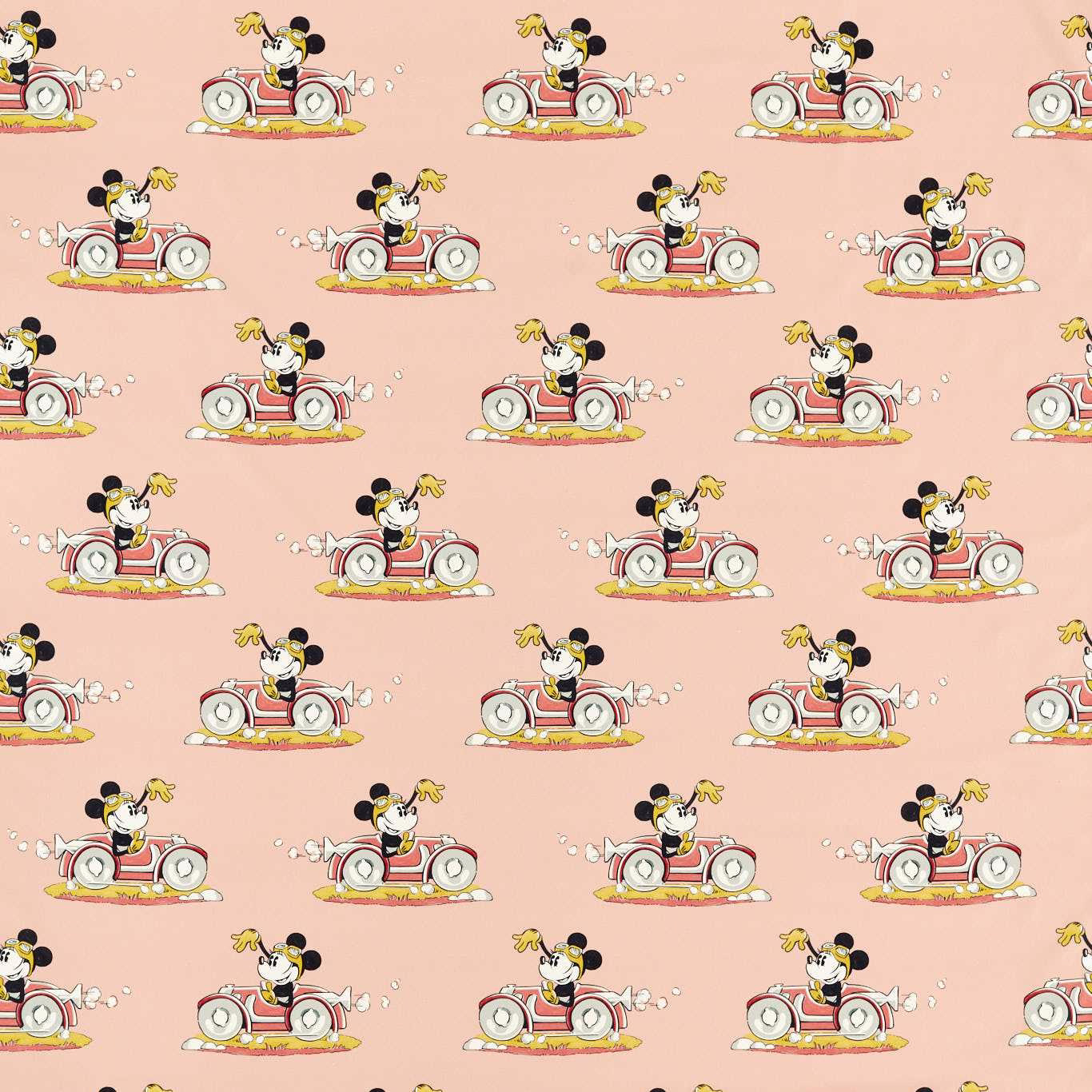Minnie Mouse driving a red car on soft pink printed fabric
