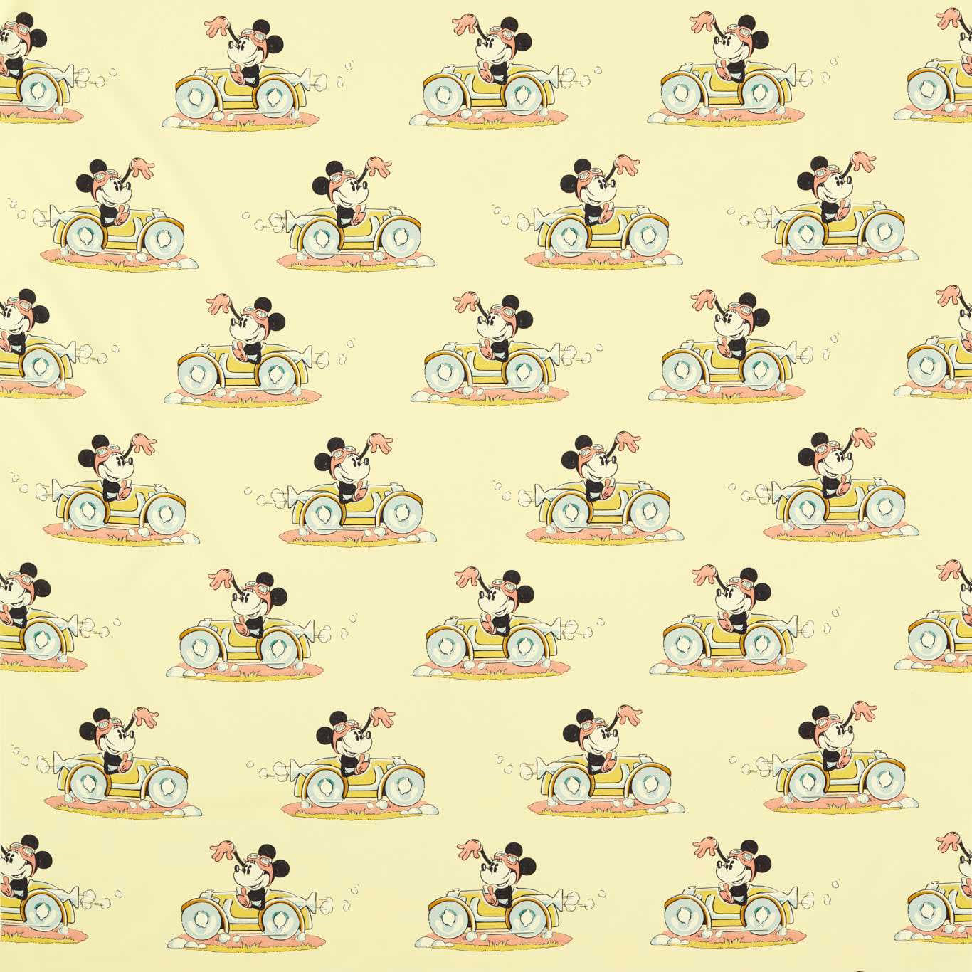 Minnie Mouse driving a small car on soft sherbet yellow fabric