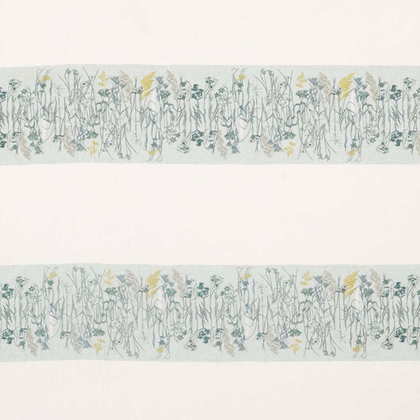 Misty blue-green botanical border fabric with pale ground and yellow flower accents