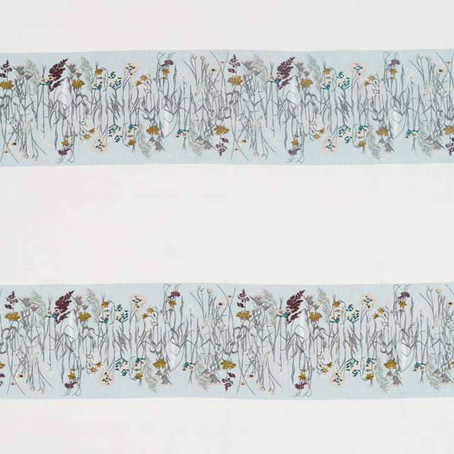 Swatch of floral fabric with pale blue ground and slender meadow stems