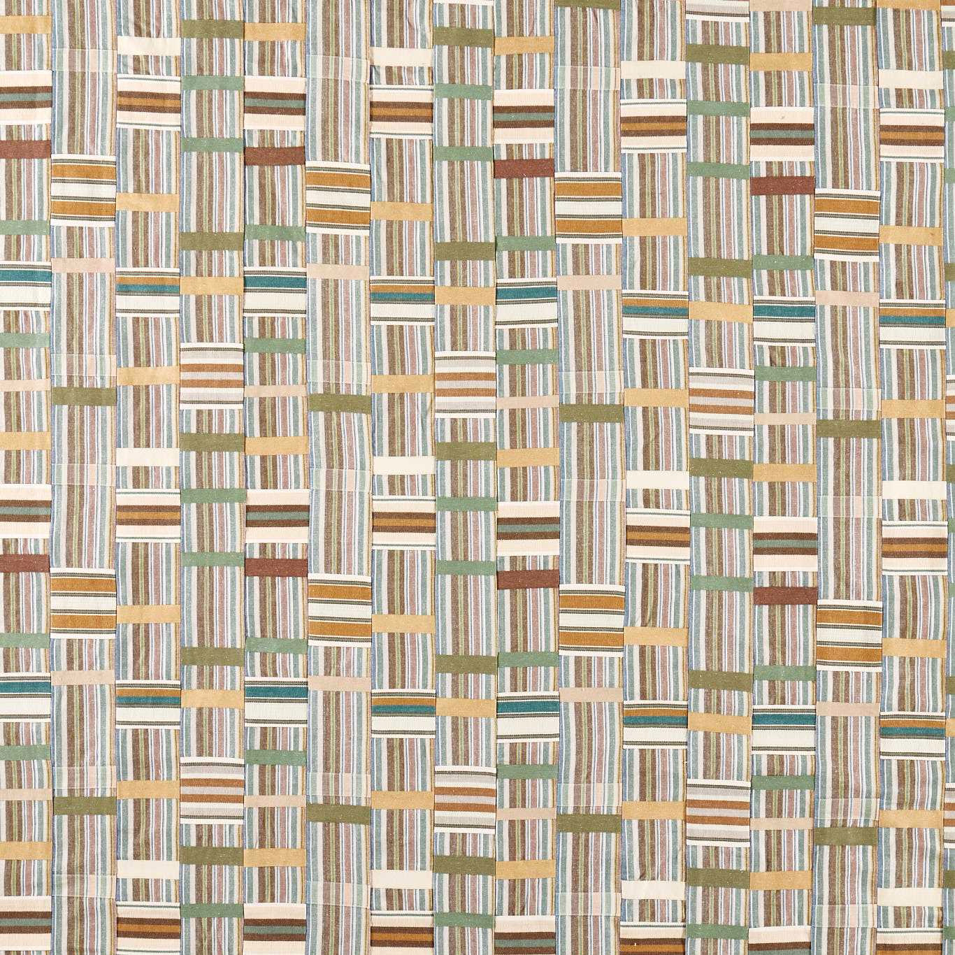 Patchwork woven fabric with lichen green, cream and earthy striped blocks