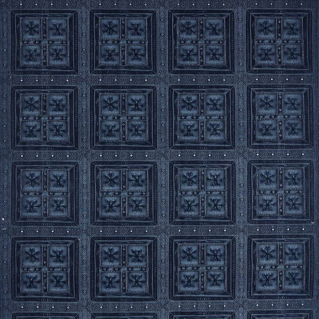 Dark denim-blue geometric fabric with raised square motifs and floral centres